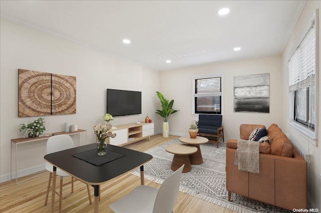 living room featuring light hardwood / wood-style floors and ornamental molding