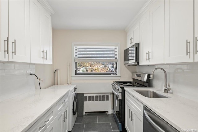 kitchen with white cabinetry, radiator heating unit, and appliances with stainless steel finishes