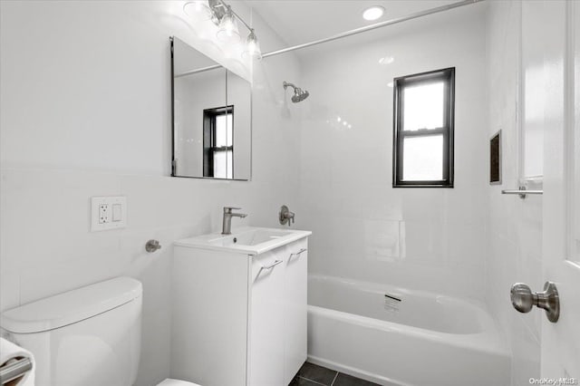 full bathroom featuring tile patterned floors, vanity, toilet, and tile walls