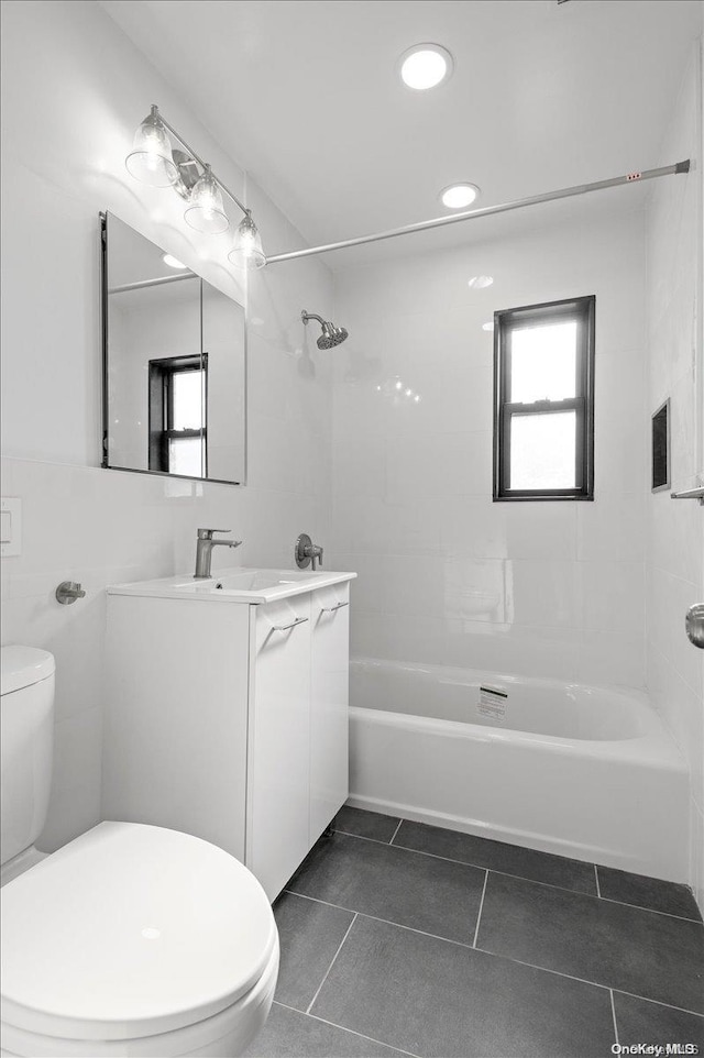 full bathroom with tile patterned floors, vanity, toilet, and tiled shower / bath