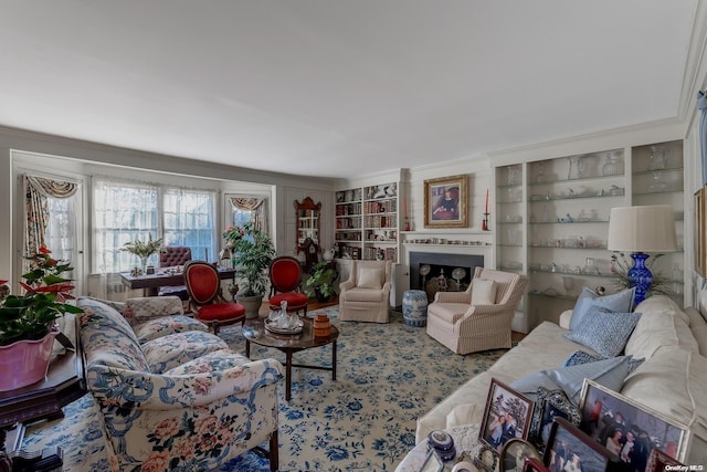 living room with built in features and crown molding