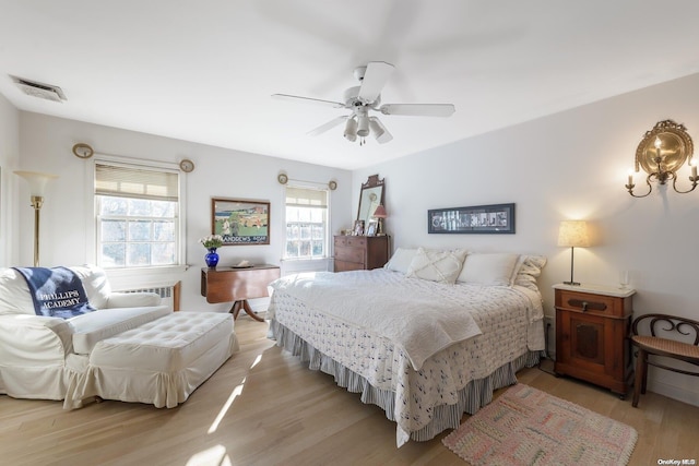 bedroom with ceiling fan and light hardwood / wood-style flooring