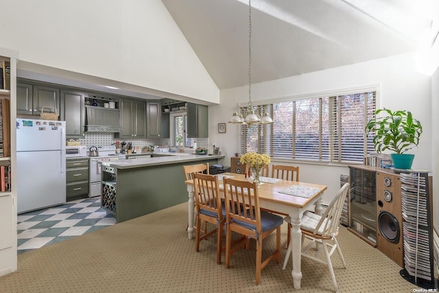 dining room with high vaulted ceiling