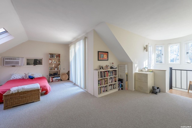 bedroom with lofted ceiling, a wall unit AC, and carpet flooring