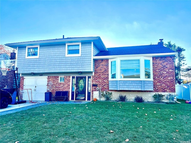 split level home with a garage and a front yard