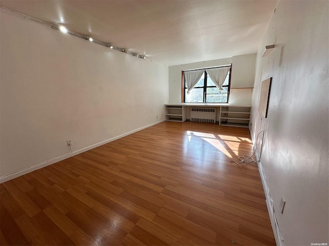 interior space featuring radiator heating unit and wood-type flooring