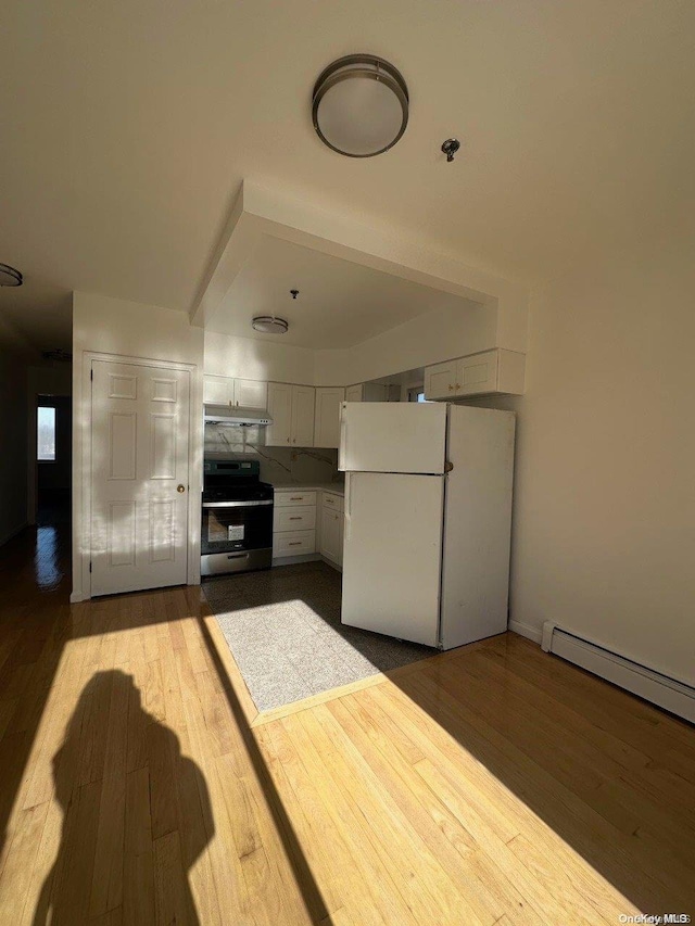 kitchen with white cabinetry, light hardwood / wood-style flooring, white fridge, and stainless steel range oven