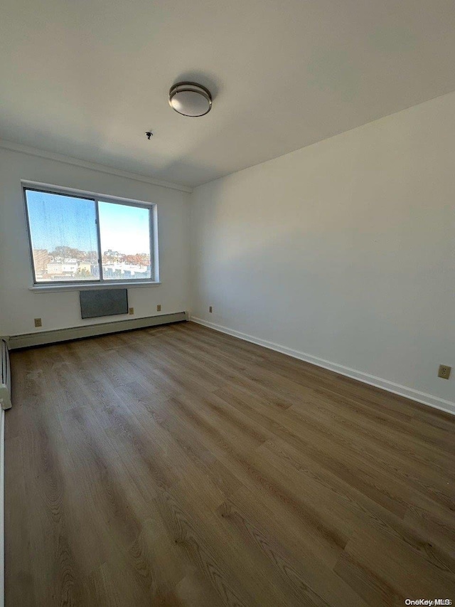 unfurnished room with wood-type flooring