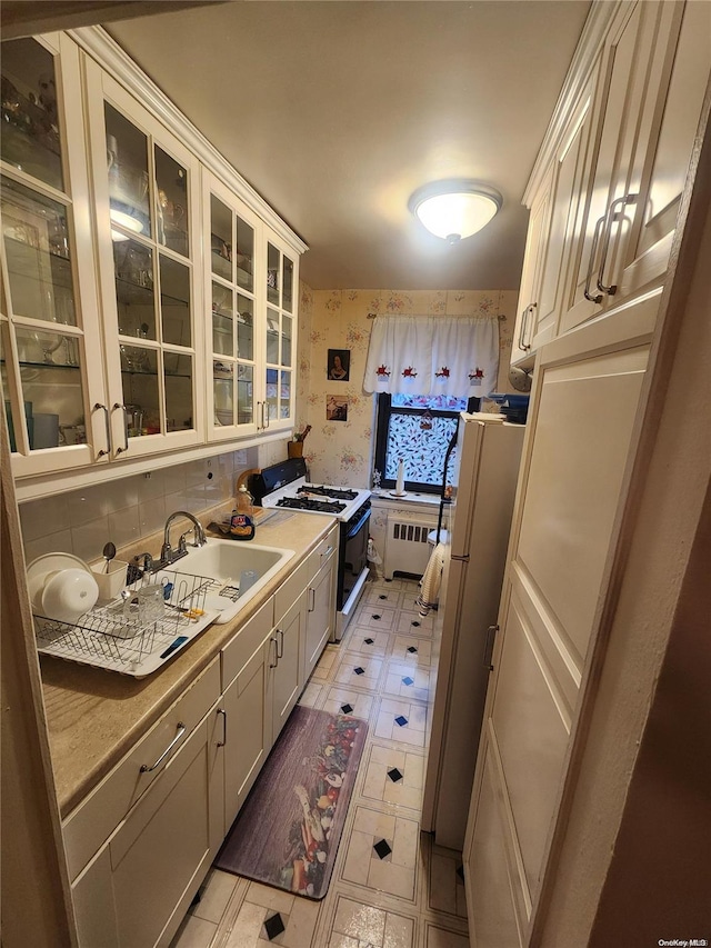 kitchen with white appliances, sink, and tasteful backsplash