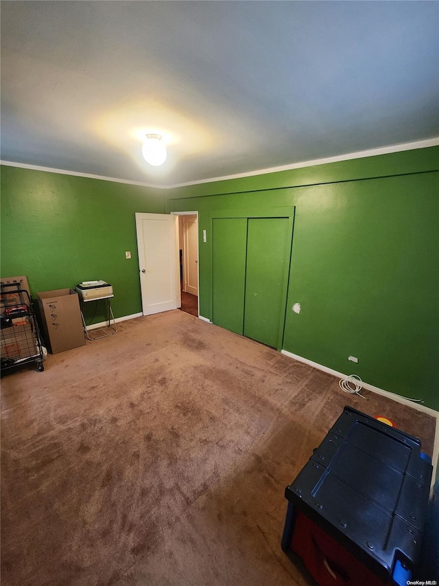 carpeted bedroom featuring a closet and ornamental molding