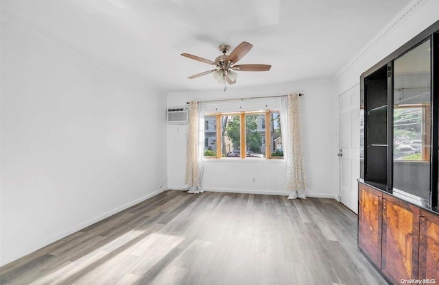 unfurnished room featuring ceiling fan, ornamental molding, a wall unit AC, and light hardwood / wood-style flooring