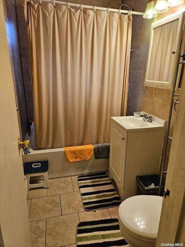 full bathroom featuring shower / bath combination with curtain, vanity, toilet, and tile patterned floors