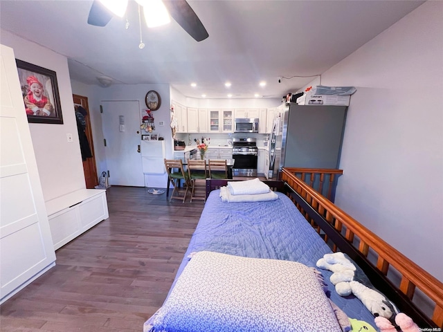 bedroom with ceiling fan and dark hardwood / wood-style floors