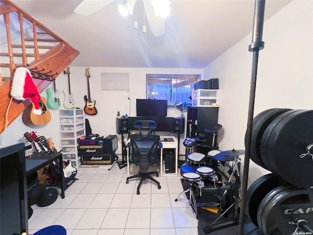 tiled home office featuring ceiling fan