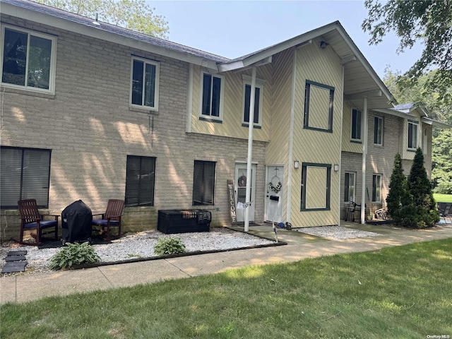 rear view of property with a lawn