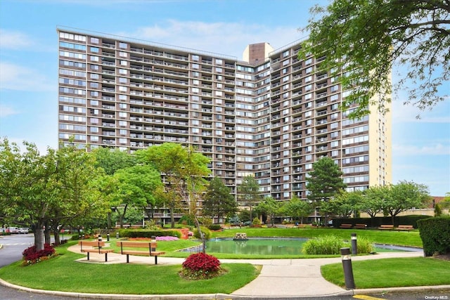 surrounding community featuring a lawn and a water view