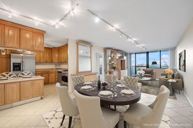 dining area featuring light tile patterned floors and track lighting