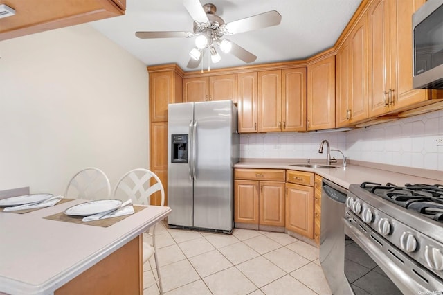 kitchen with decorative backsplash, stainless steel appliances, ceiling fan, sink, and light tile patterned flooring