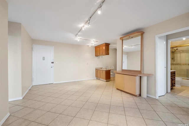 interior space featuring light tile patterned floors and track lighting