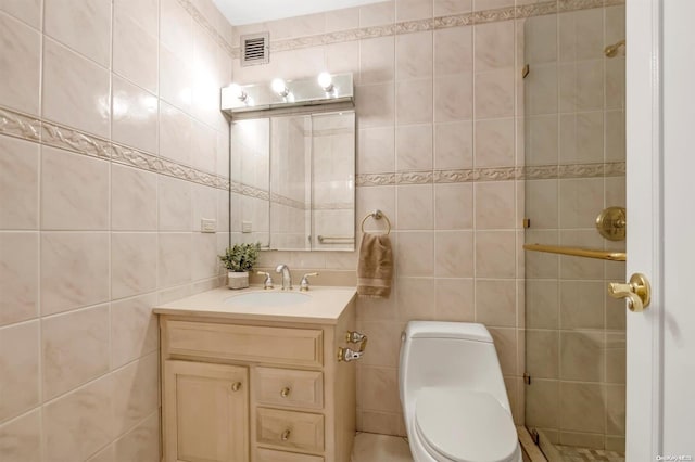 bathroom with vanity, toilet, and tile walls