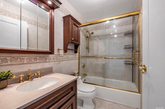 full bathroom with vanity, tile patterned floors, toilet, enclosed tub / shower combo, and tile walls