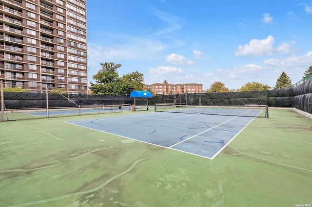 view of tennis court featuring basketball hoop