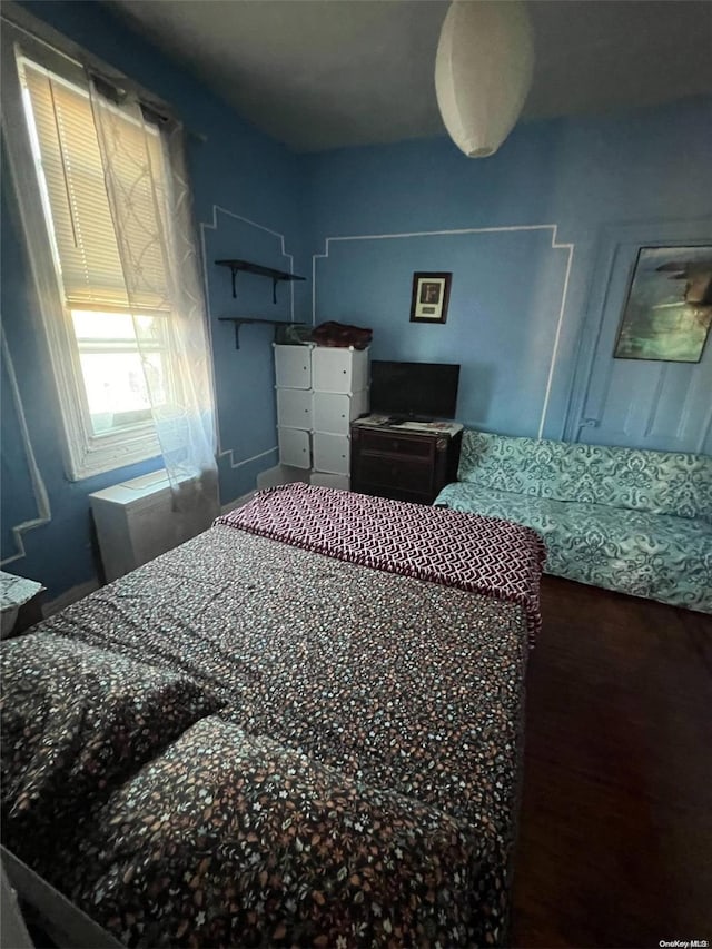 bedroom with wood-type flooring