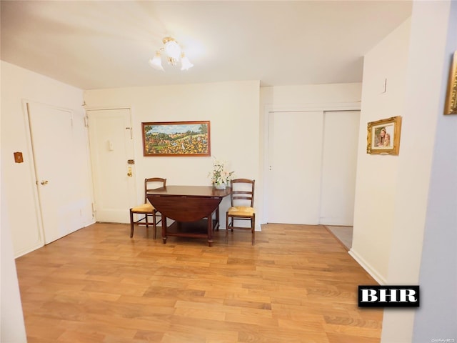 dining room featuring light hardwood / wood-style floors and an inviting chandelier