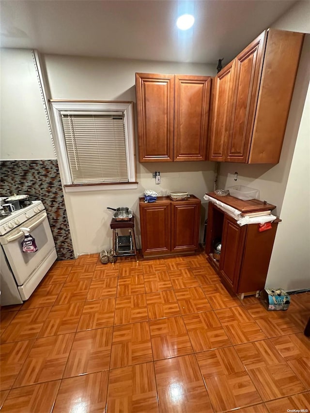 kitchen with light parquet flooring and white stove