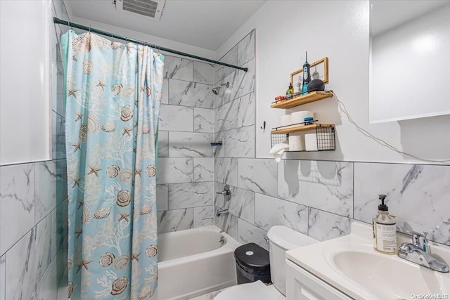 full bathroom with vanity, shower / tub combo, tile walls, and toilet