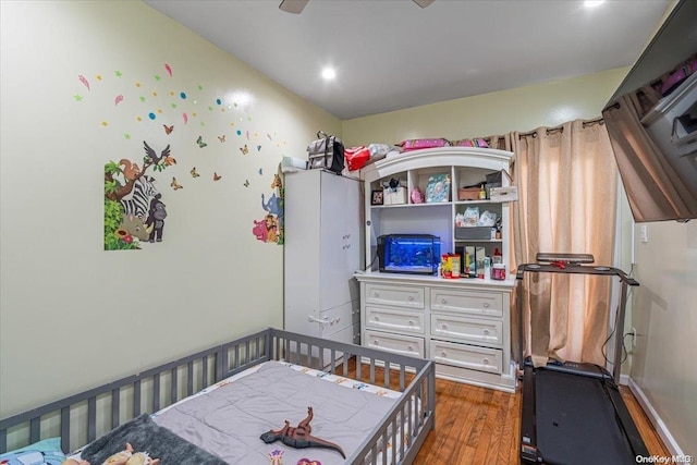 bedroom with dark hardwood / wood-style flooring and ceiling fan