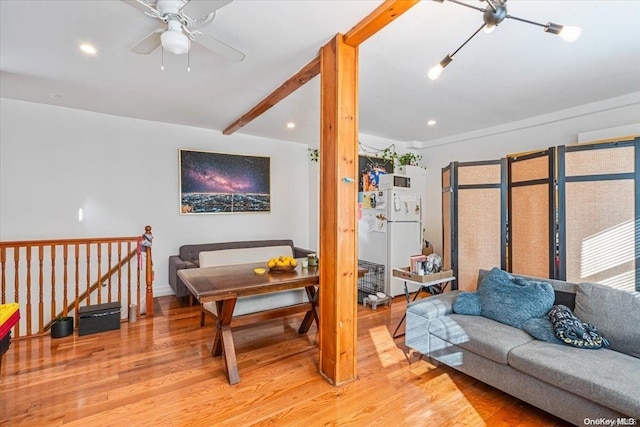 living room with wood-type flooring, ceiling fan, and beam ceiling