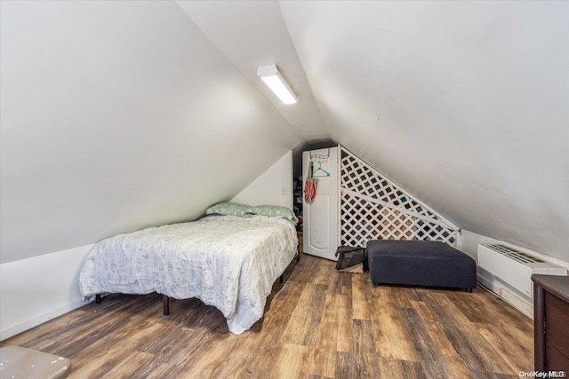 bedroom featuring an AC wall unit, dark wood-type flooring, and vaulted ceiling