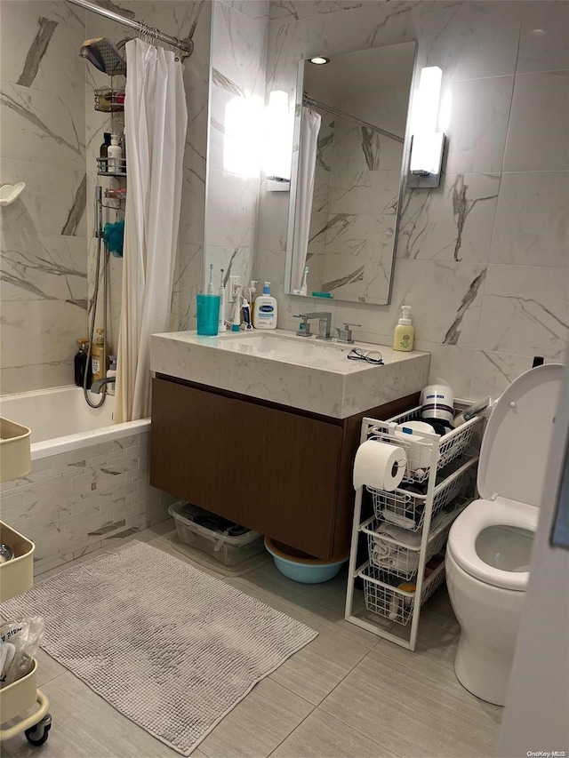 full bathroom featuring shower / bath combo with shower curtain, vanity, tile walls, and toilet