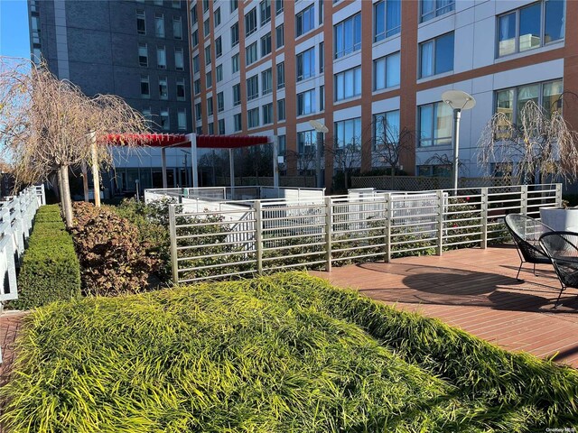 138-35 39th Ave Unit 10F, Flushing, NY 11354 - view of property's community with a wooden deck