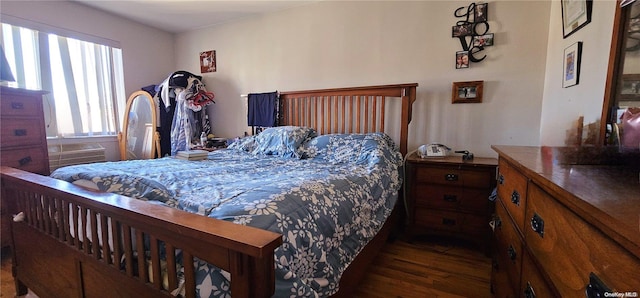 bedroom with dark hardwood / wood-style flooring