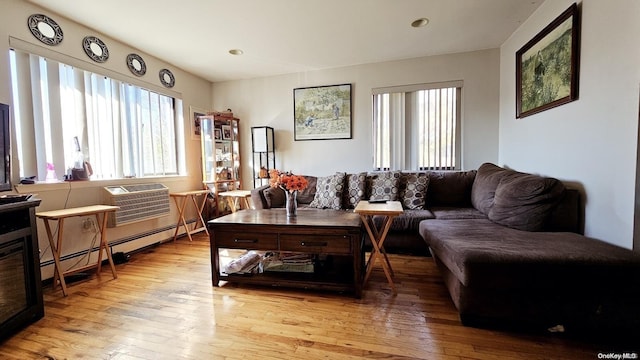 living room with light wood-type flooring and a baseboard radiator