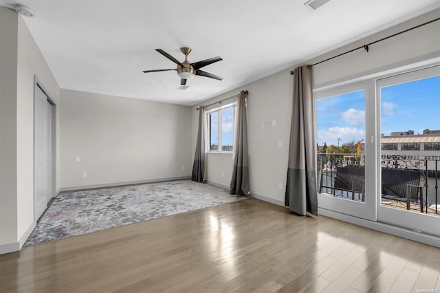 interior space featuring ceiling fan, light hardwood / wood-style floors, and a wealth of natural light