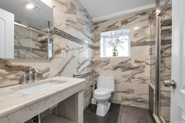 bathroom with sink, an enclosed shower, tile walls, and toilet