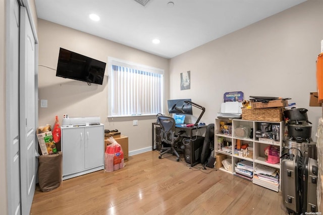 office with light wood-type flooring