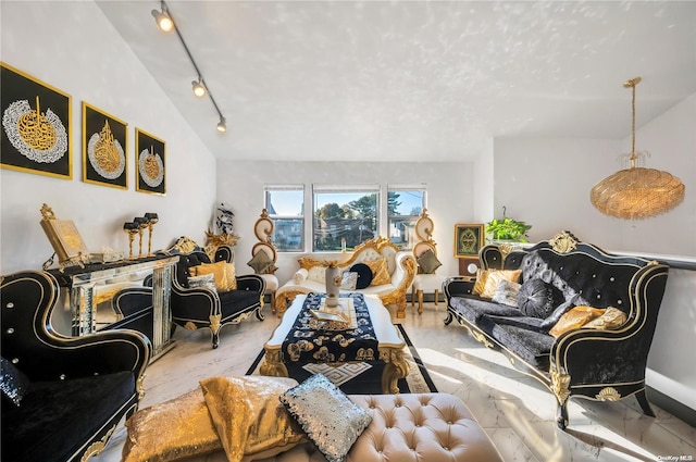 living room featuring lofted ceiling and track lighting