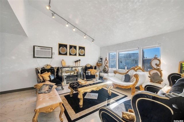 living room with vaulted ceiling, a wall unit AC, and track lighting