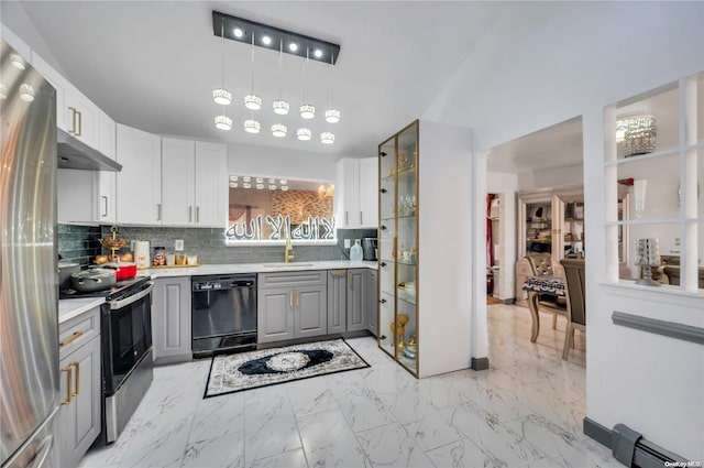 kitchen featuring gray cabinetry, sink, decorative backsplash, appliances with stainless steel finishes, and decorative light fixtures