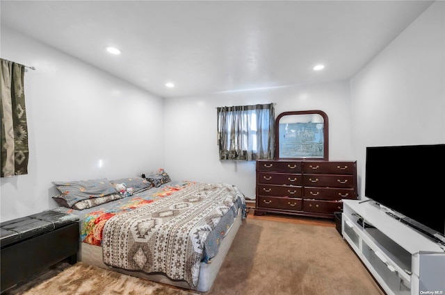 bedroom featuring light carpet