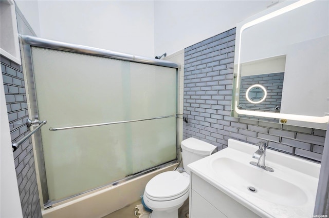 full bathroom with vanity, toilet, enclosed tub / shower combo, and tasteful backsplash