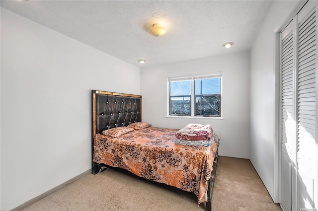 carpeted bedroom featuring a textured ceiling