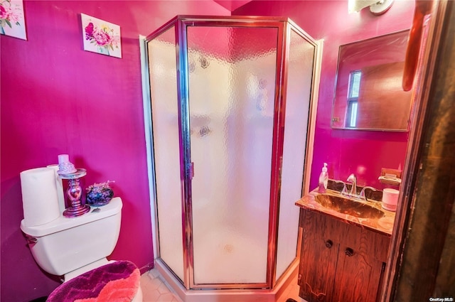 bathroom featuring tile patterned floors, vanity, toilet, and a shower with door