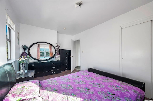 bedroom with dark hardwood / wood-style flooring