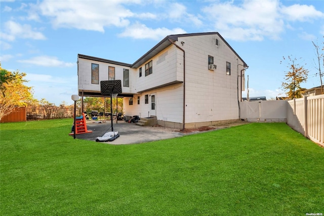 rear view of property with a lawn and a patio