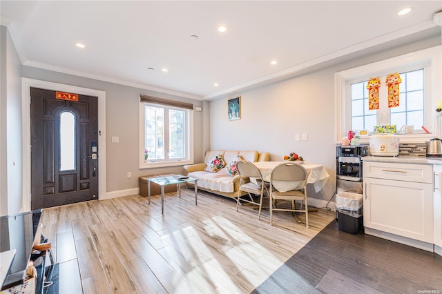 living room featuring crown molding and light hardwood / wood-style floors